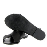 Crossed flat black leather sandal