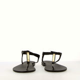 Black flip-flop sandal with strap and gold accessory