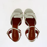 Medium heel sandal in white leather with raw cut