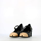 Black leather strap shoe with gold toe