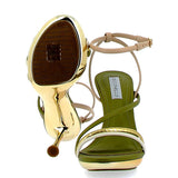 Green and gold high sandal on a gold background