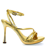 High gold sandal with snake finish on a golden background