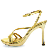 Sandalo alto oro finitura snake su fondo dorato
