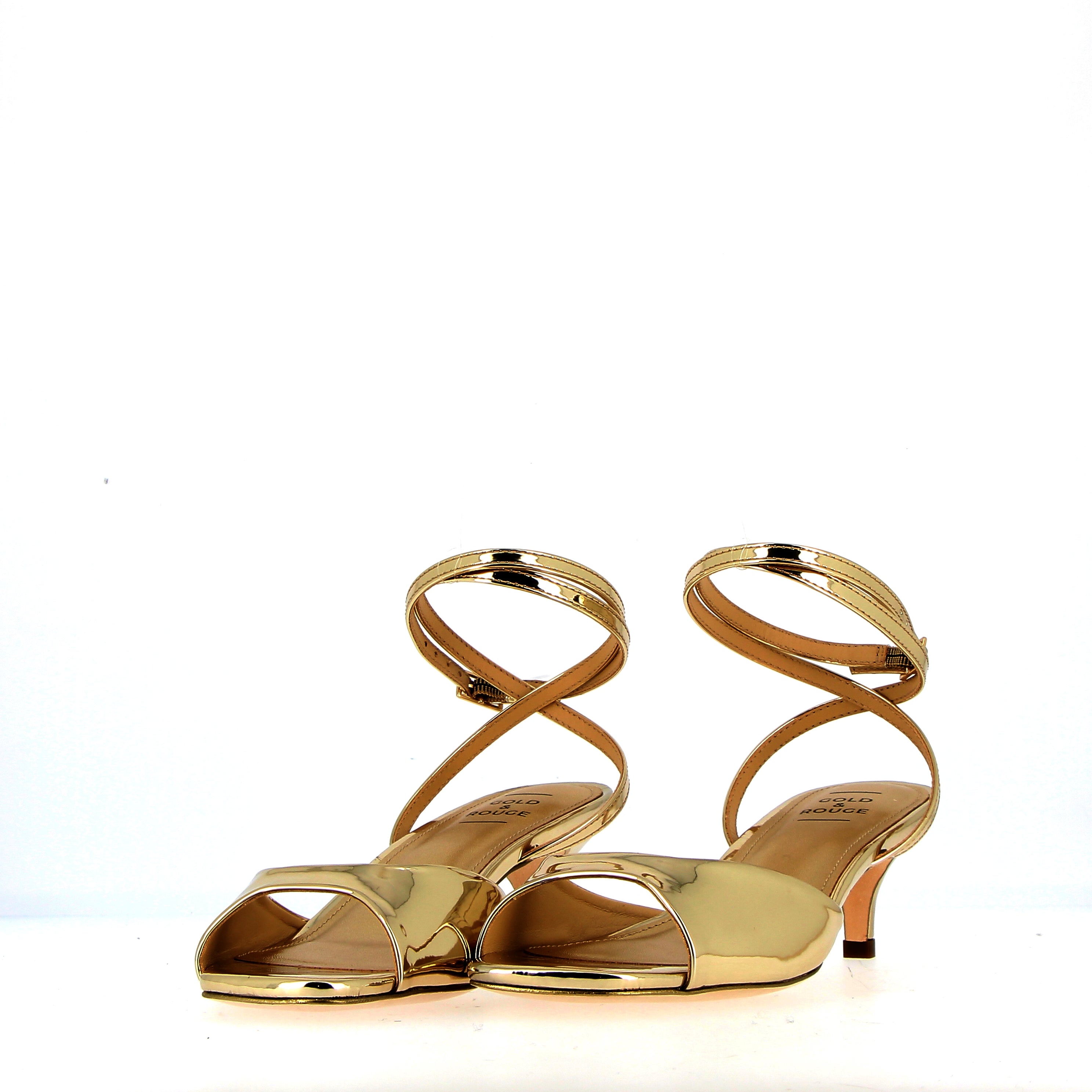 Low heel sandal in gold metal leather with strap