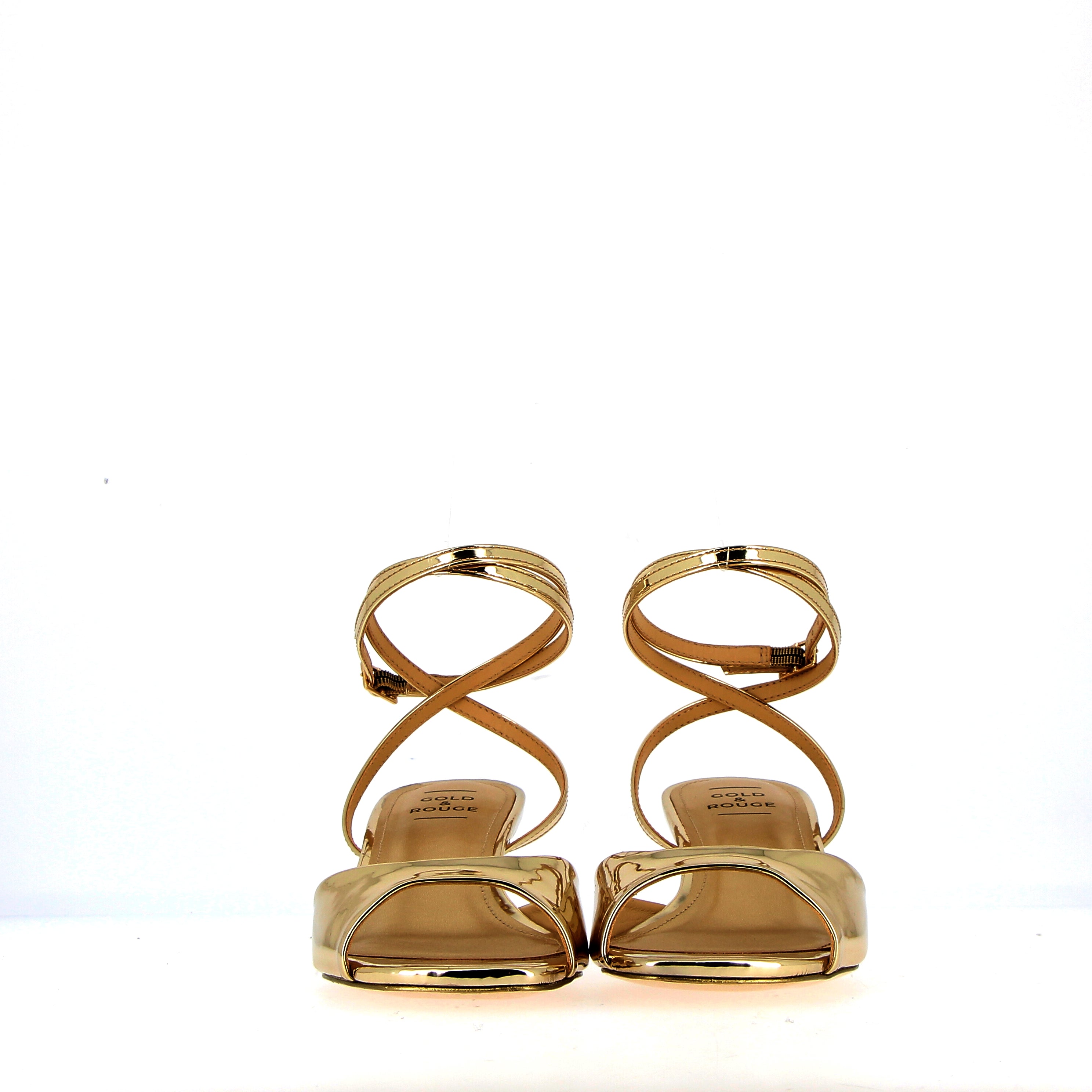 Low heel sandal in gold metal leather with strap