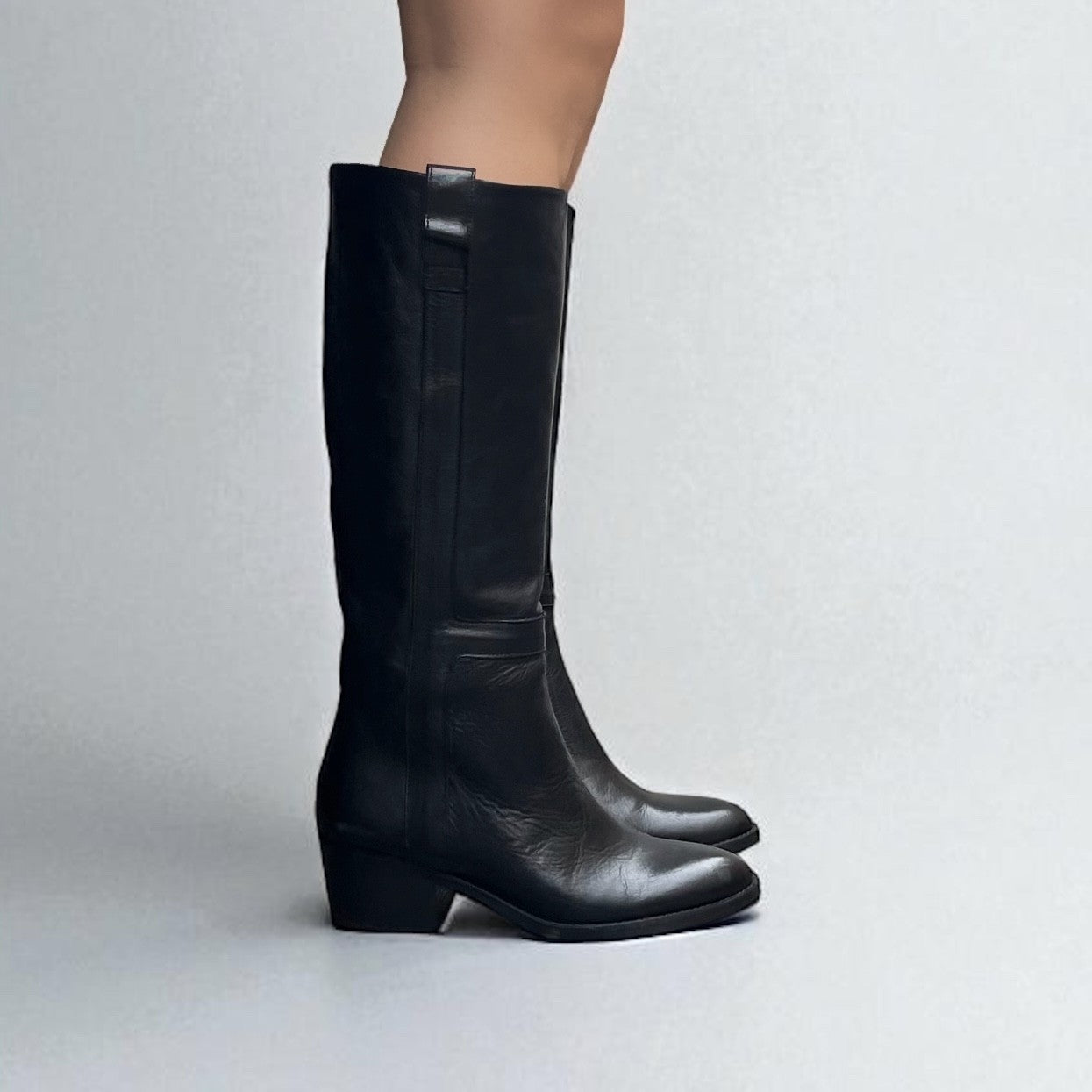 Black leather boot with a medium heel.
