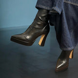 Black leather and faux ostrich ankle boot with platform.