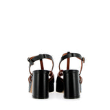 Black sandal in raw cut leather with platform
