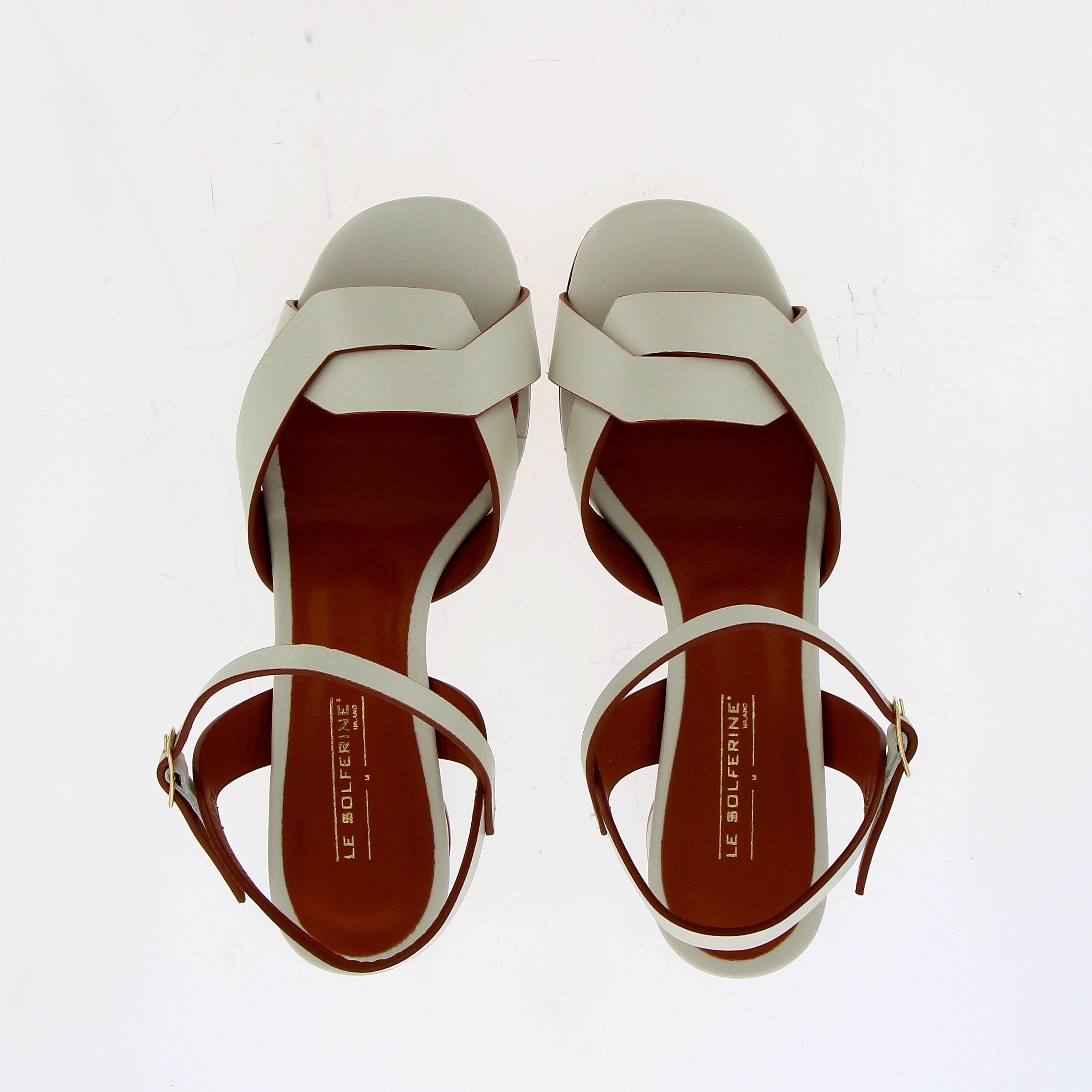 Medium heel sandal in white leather with raw cut