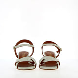 Medium heel sandal in white leather with raw cut