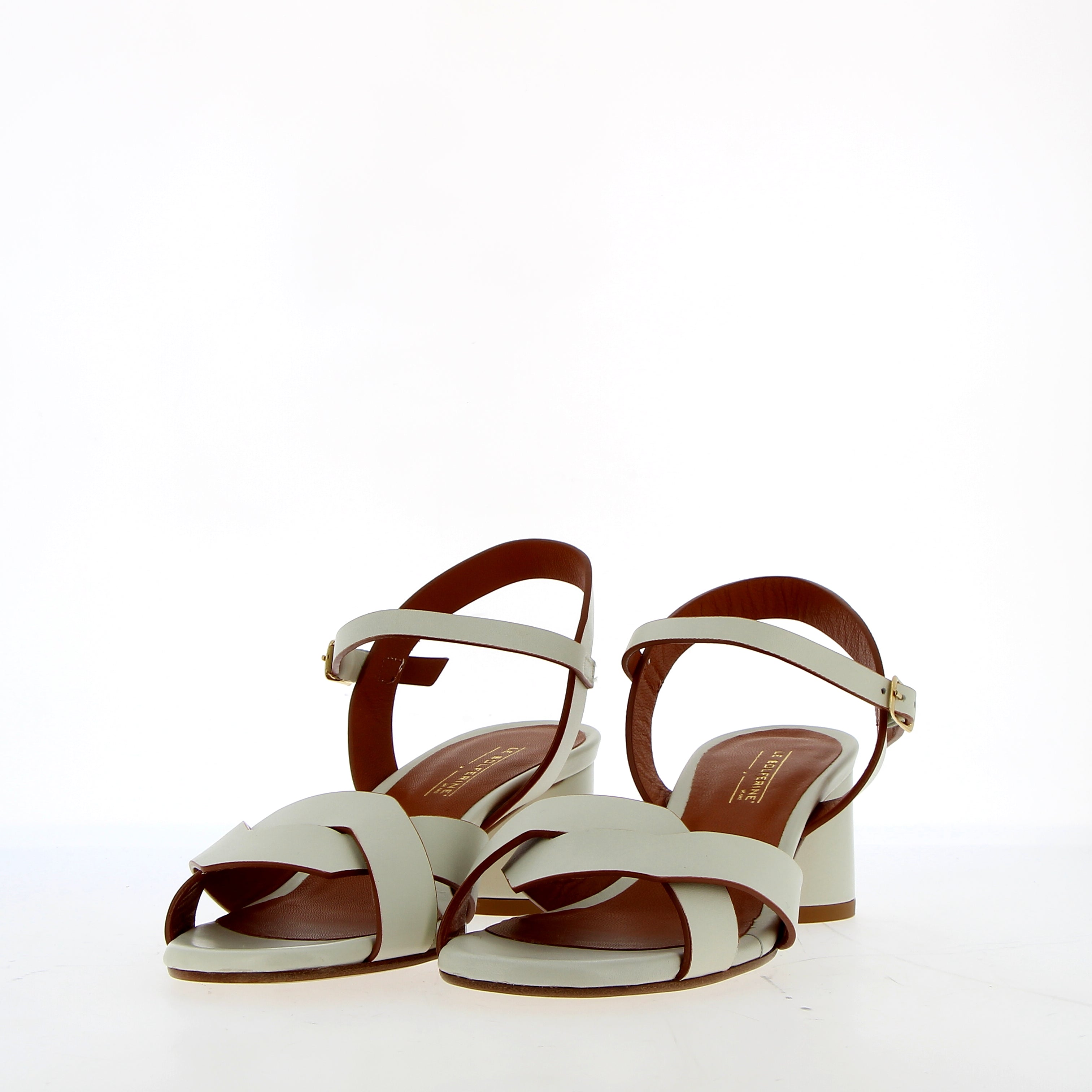 Medium heel sandal in white leather with raw cut