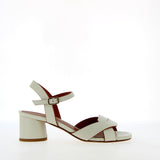 Medium heel sandal in white leather with raw cut